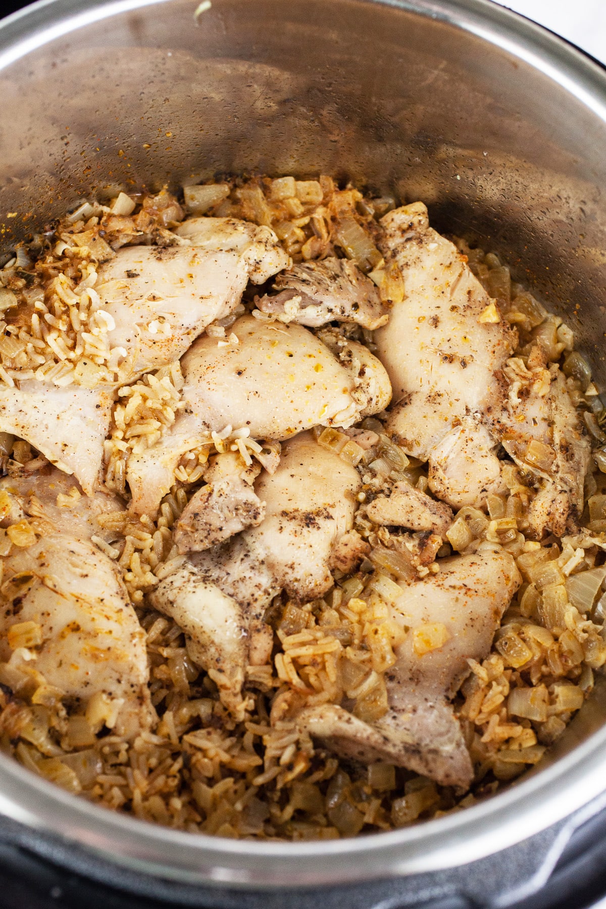 Cooked chicken thighs and rice in Instant Pot.