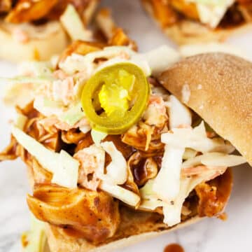 BBQ pulled chicken sandwich with coleslaw and pickled jalapenos.