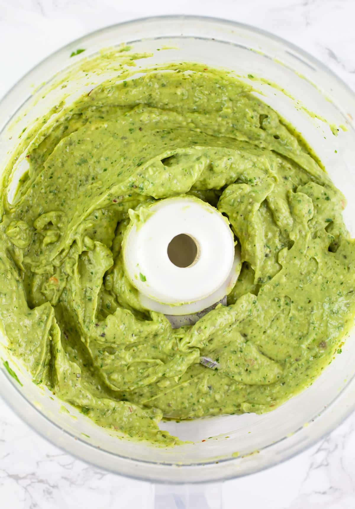 Poblano avocado dip pureed in food processor.