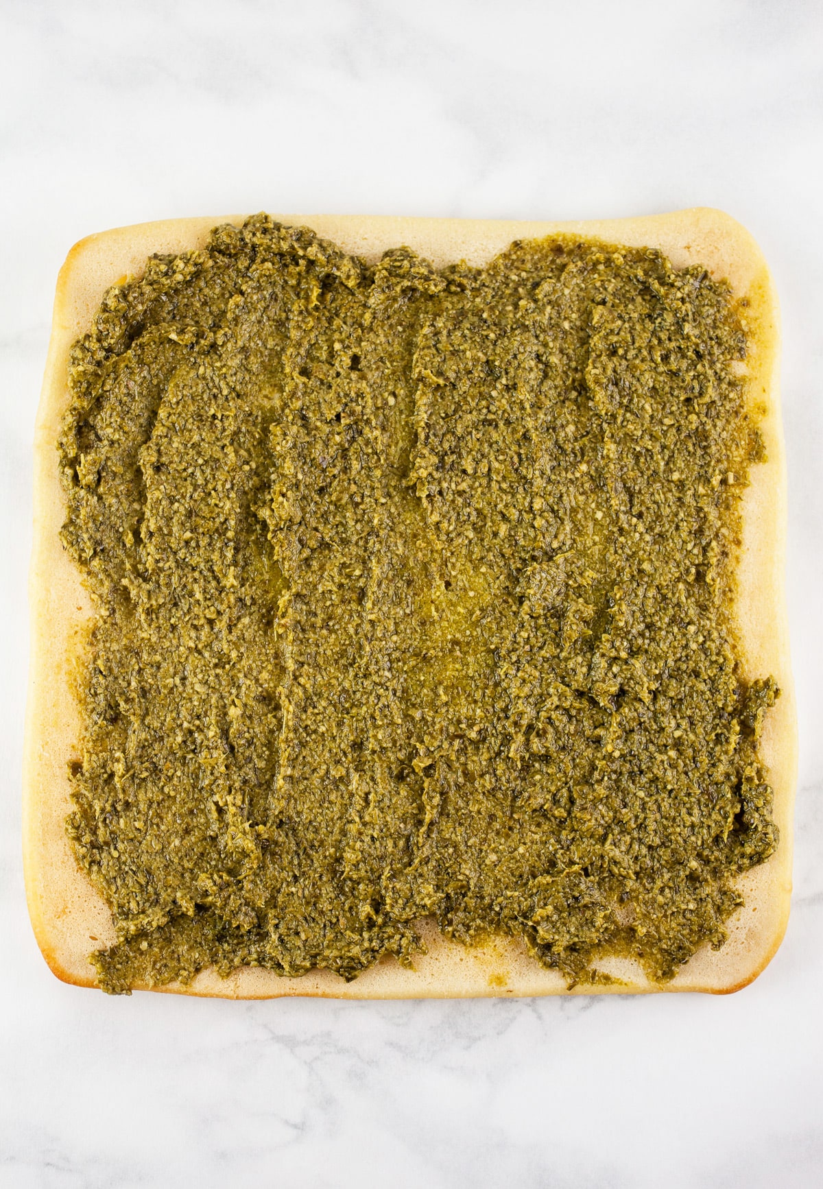 Basil pesto spread on flatbread.