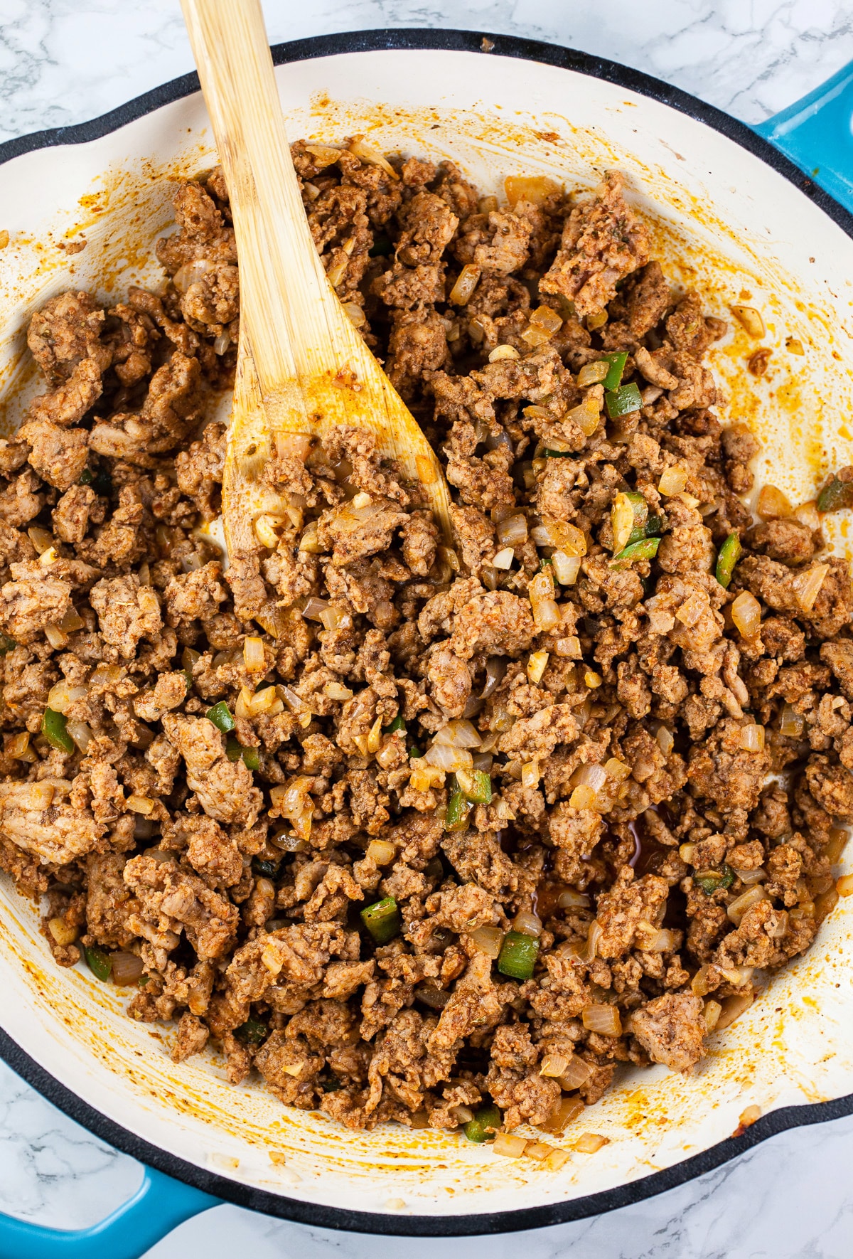 Ground turkey with spices sautéed in skillet.