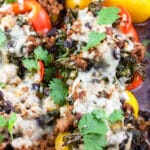 Southwest turkey stuffed peppers with cheese and cilantro in baking dish.
