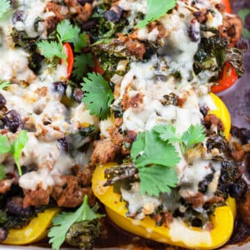 Southwest turkey stuffed peppers with cheese and cilantro in baking dish.