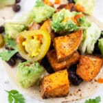 Sweet potato tacos with avocado salsa on corn tortillas.