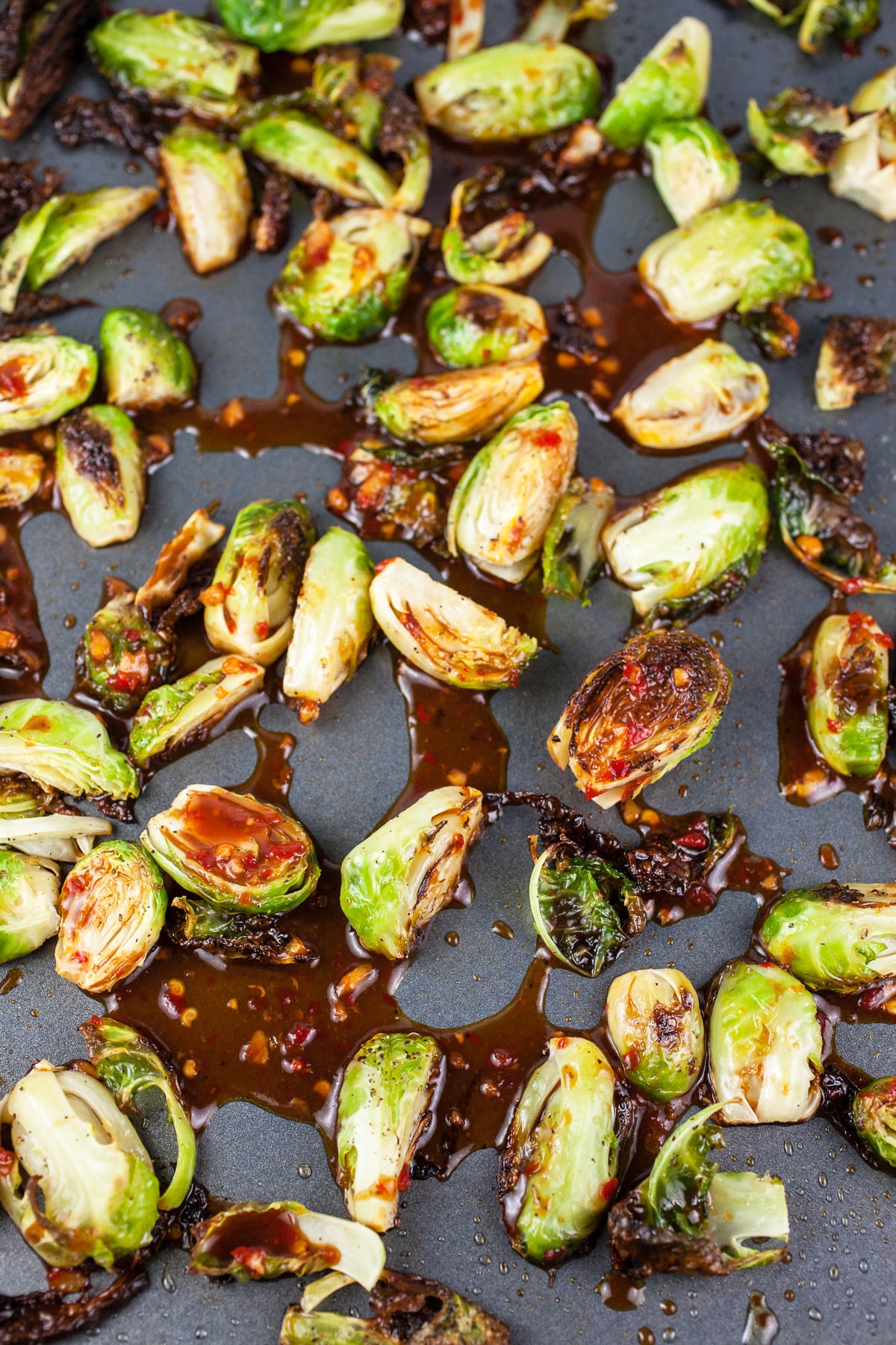 Roasted Brussels sprouts with Asian glaze on baking sheet.