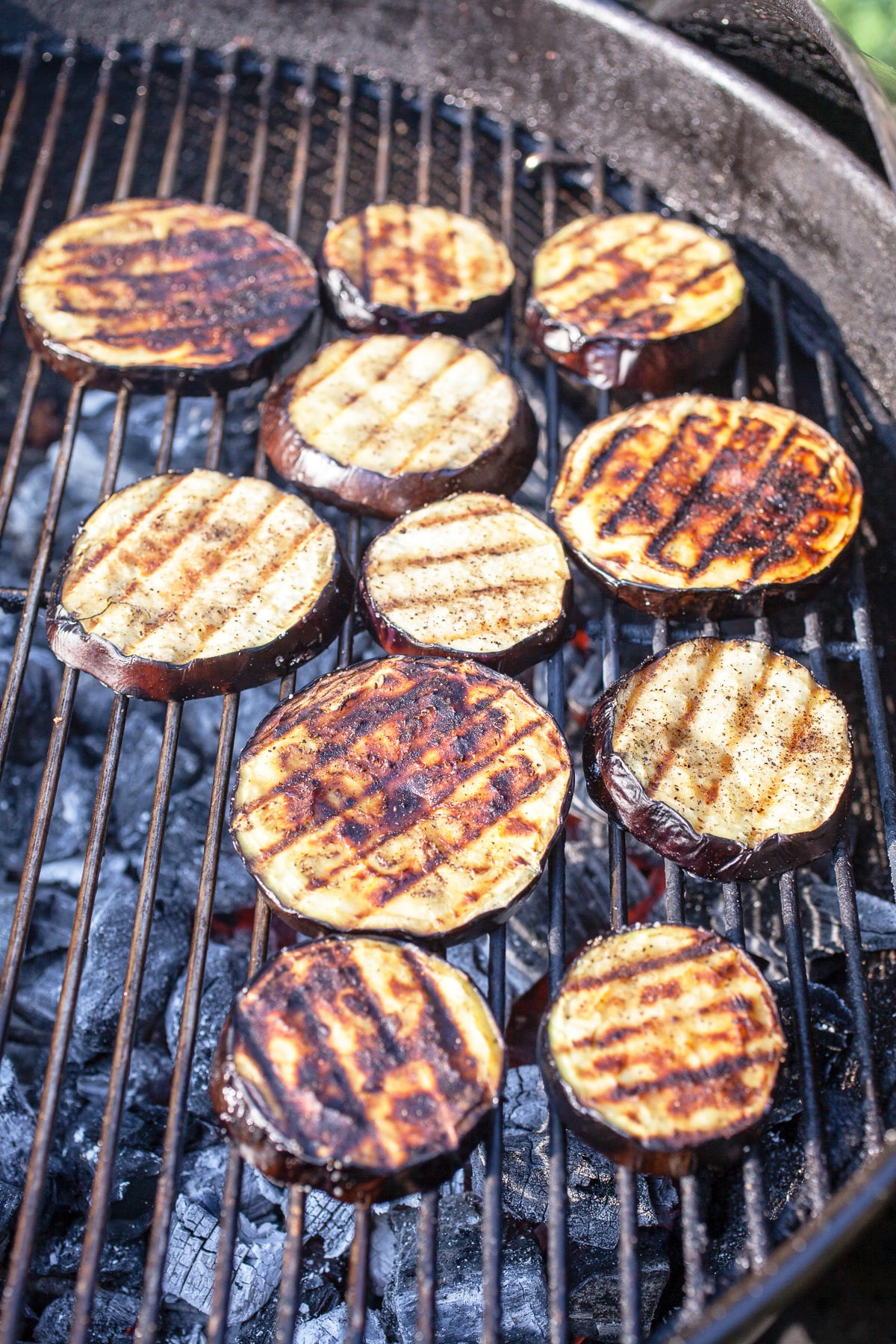 Cooked sliced eggplant on charcoal grill.