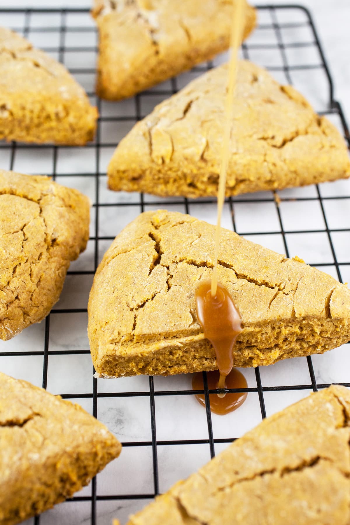 Maple glaze drizzled onto pumpkin scones.