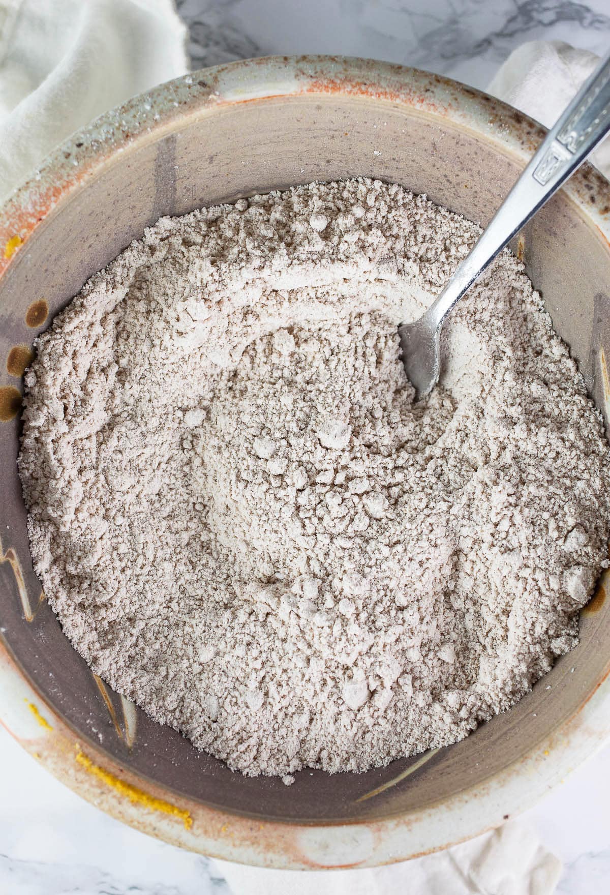 Dry scone ingredients mixed together in ceramic bowl.