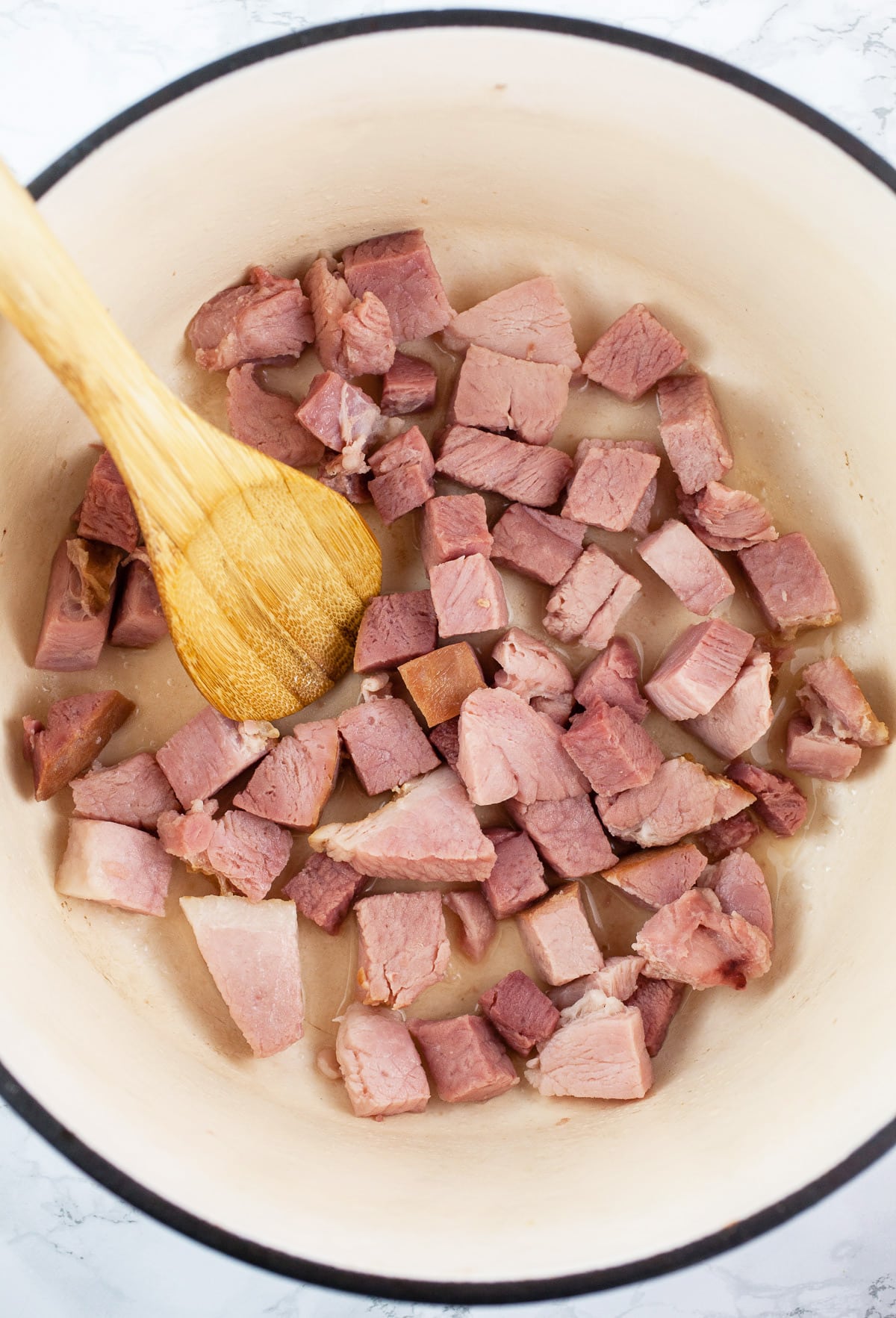 Diced ham sautéed in Dutch oven.