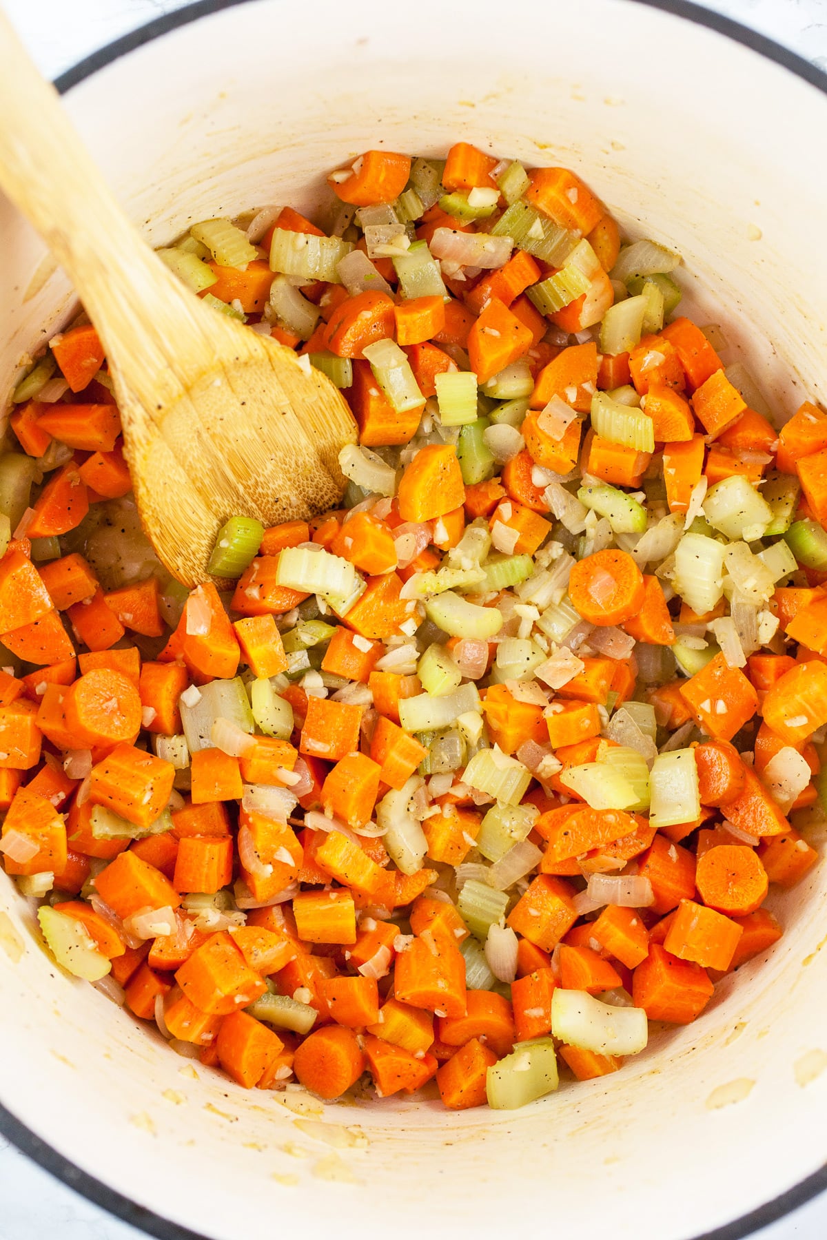 Minced garlic, onions, celery, and carrots sautéed in Dutch oven.