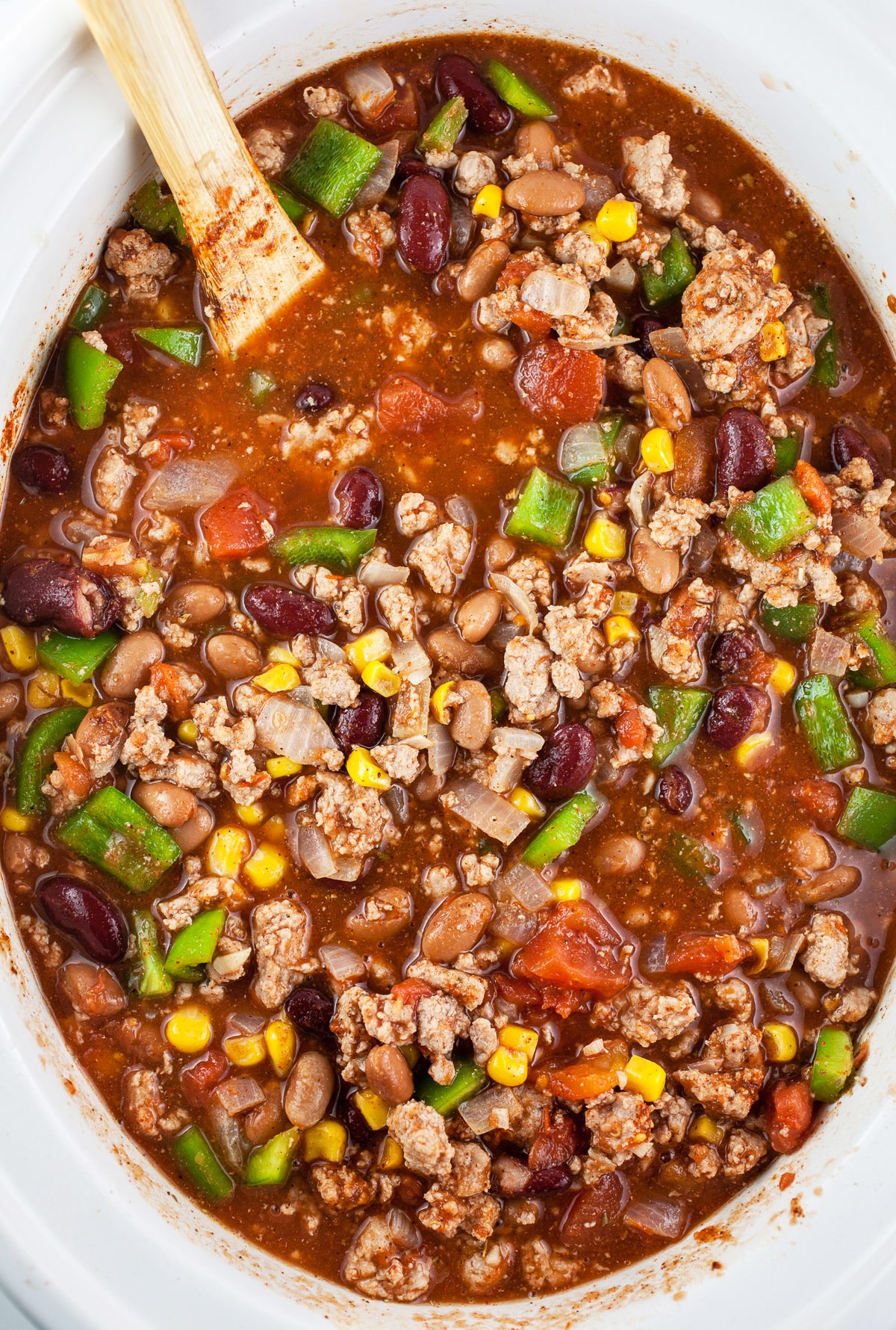 Uncooked ground turkey chili in slow cooker.
