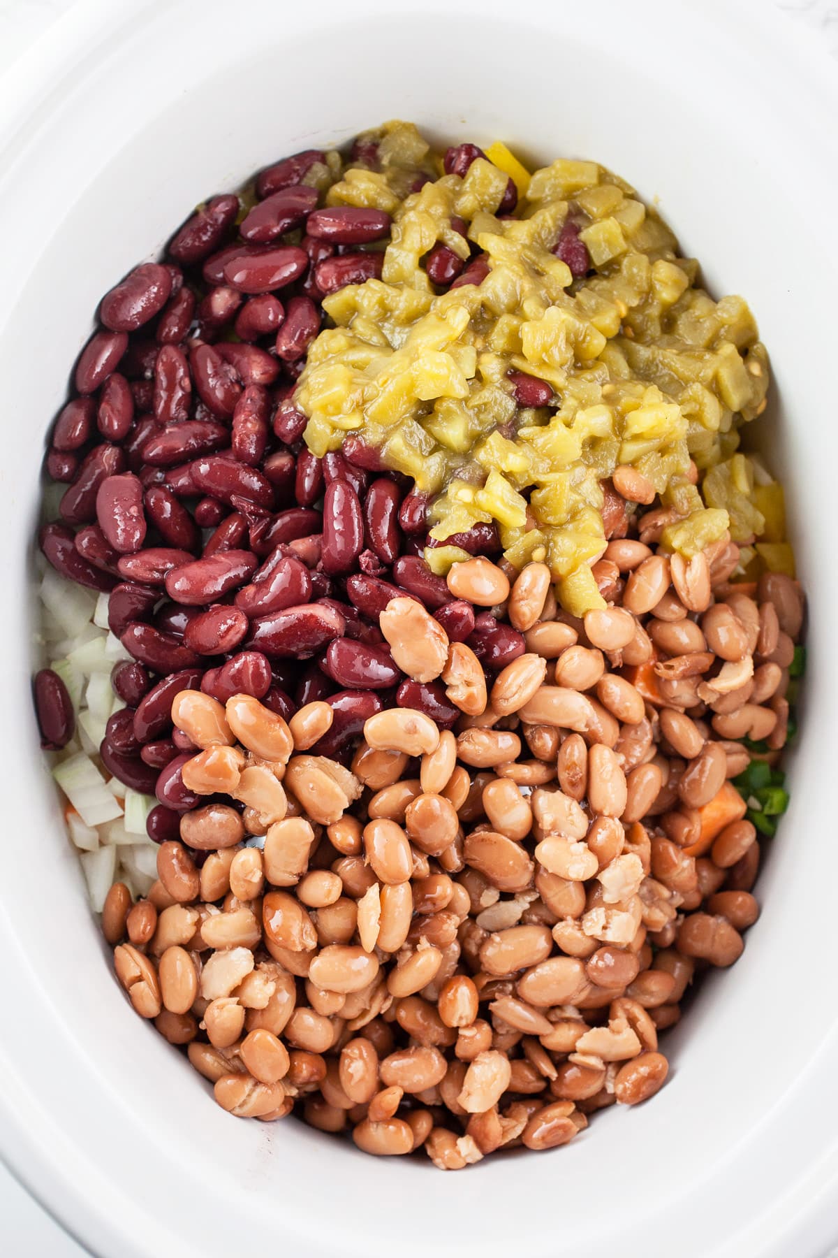 Pinto and kidney beans and diced green chilis in slow cooker.