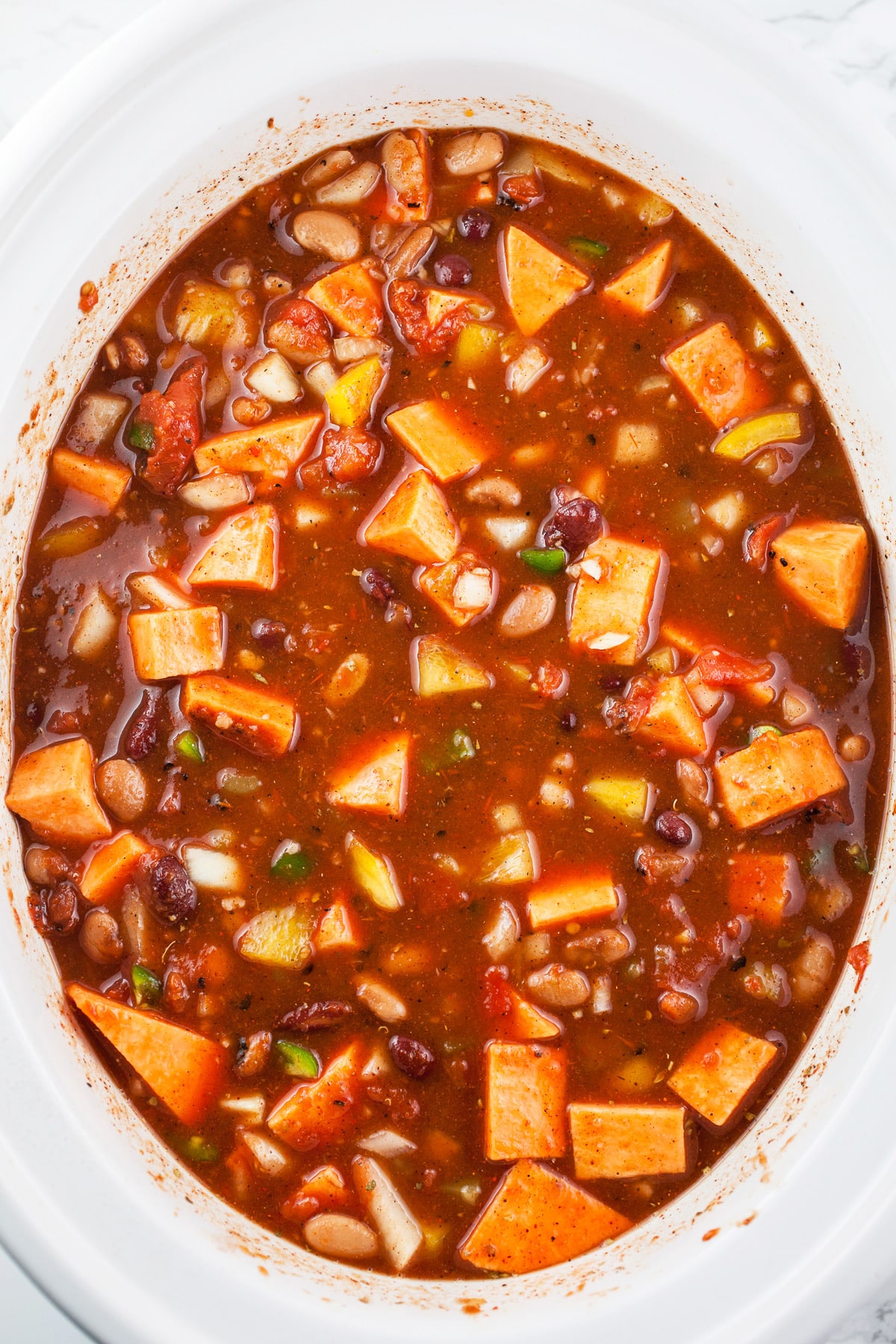 Uncooked veggie chili in slow cooker.