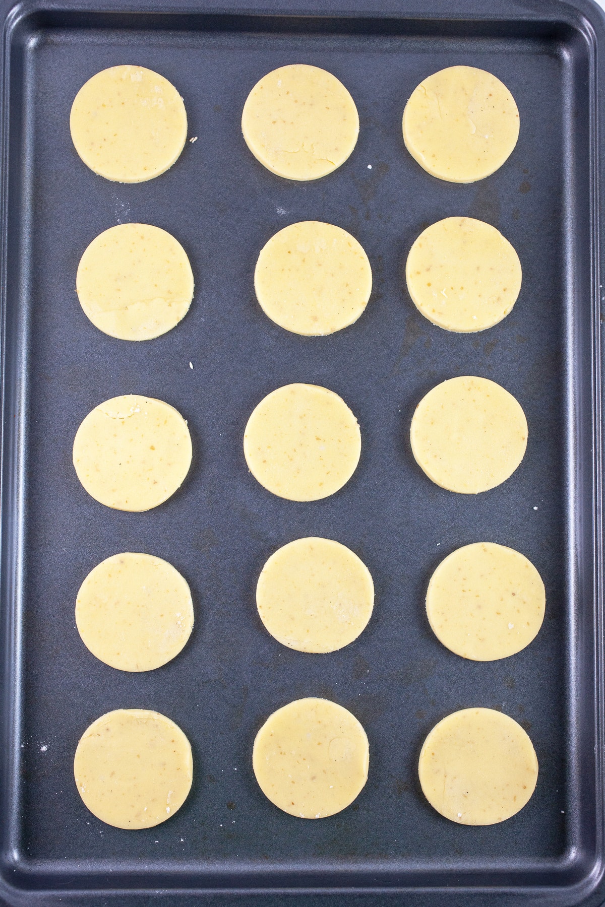 Puff pastry rounds on baking sheet.
