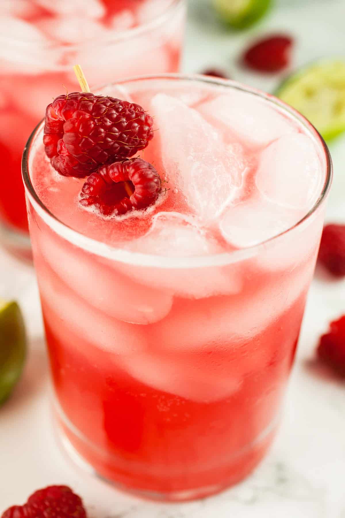 Raspberry mule cocktail in glass with fresh raspberries.