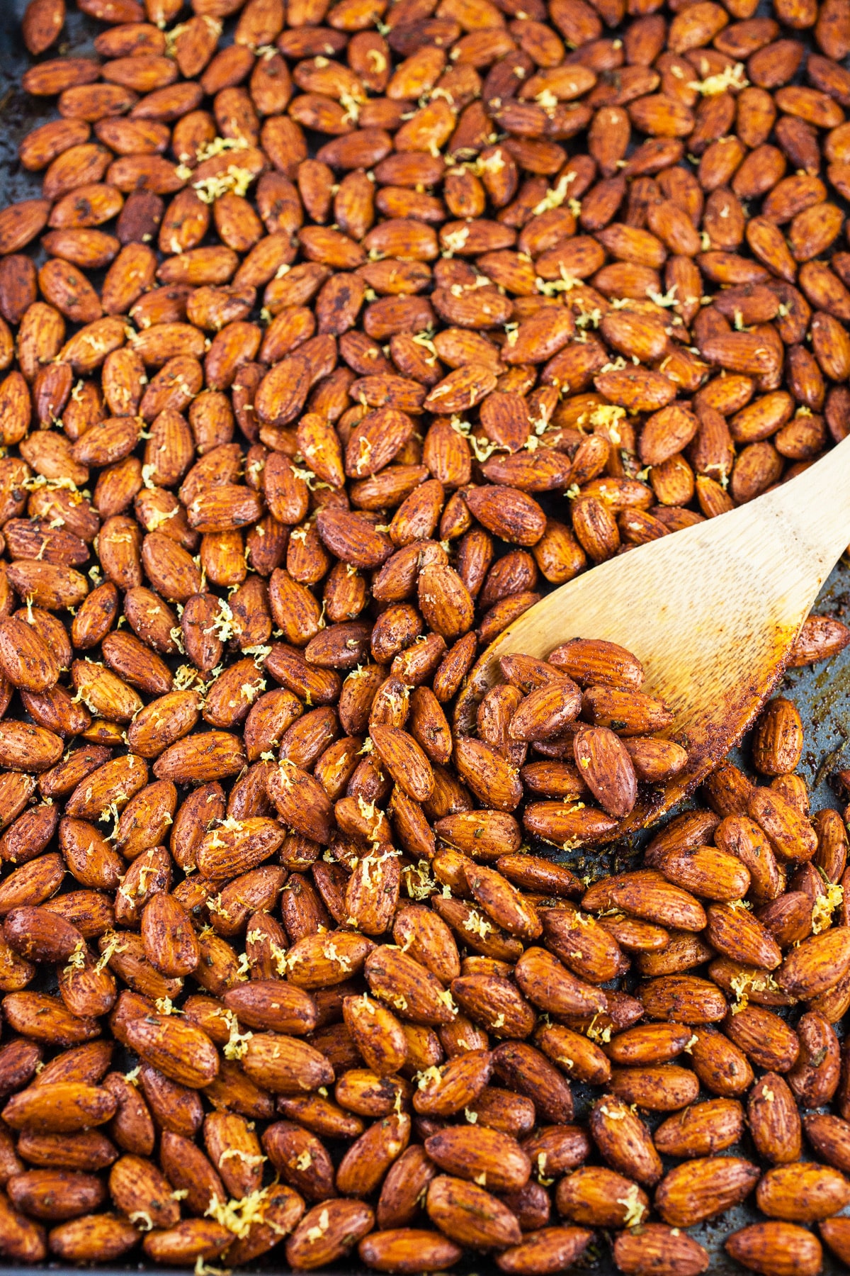 Roasted spiced almonds on baking sheet.