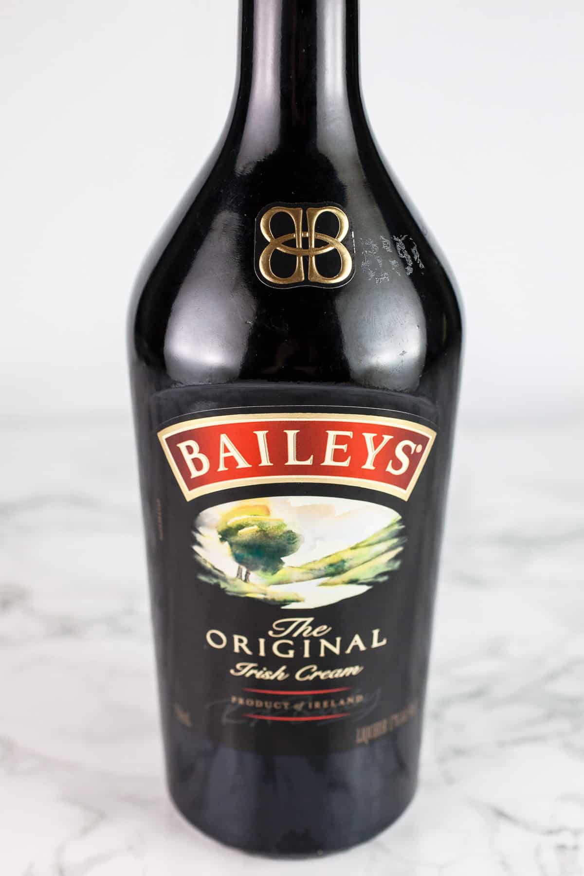 Bottle of Baileys Irish Cream on white surface.