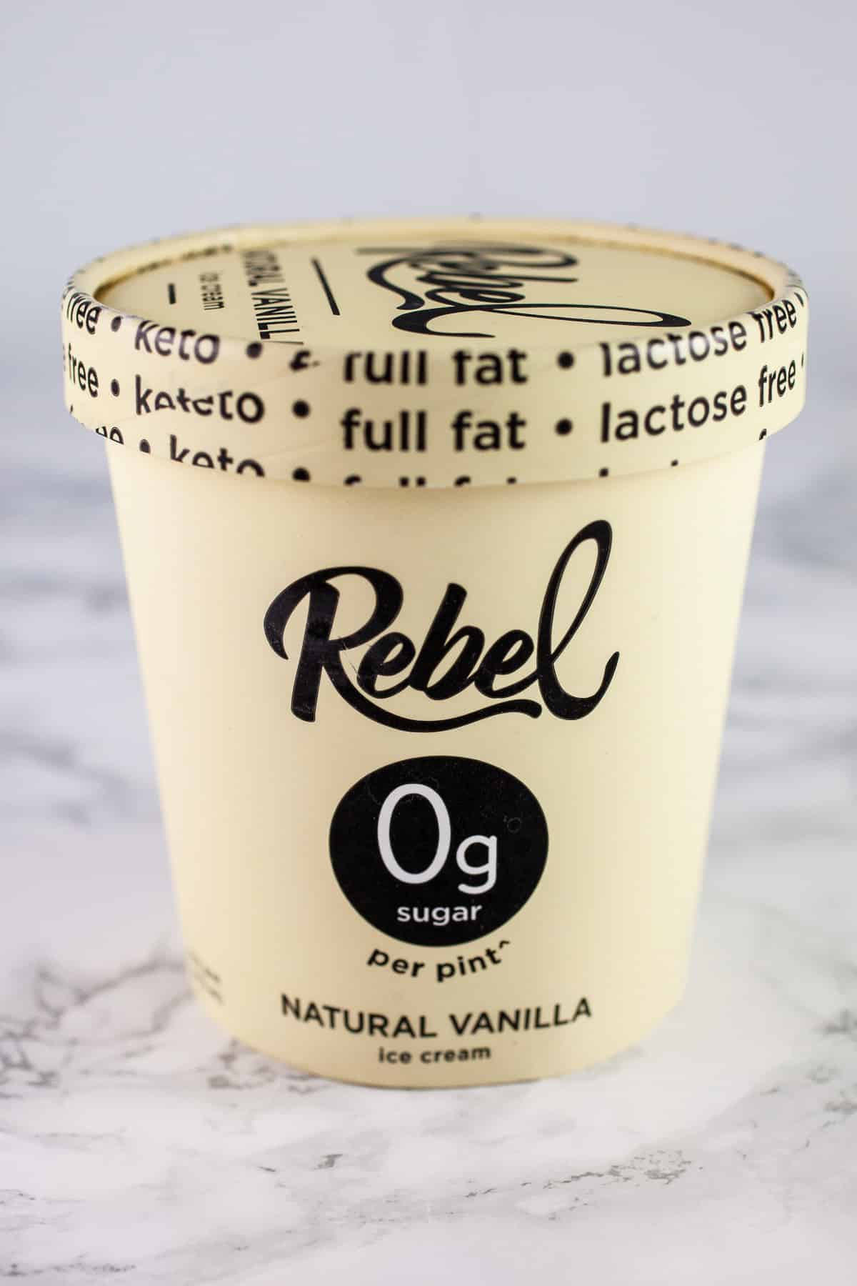 Pint of Rebel vanilla ice cream on white surface.
