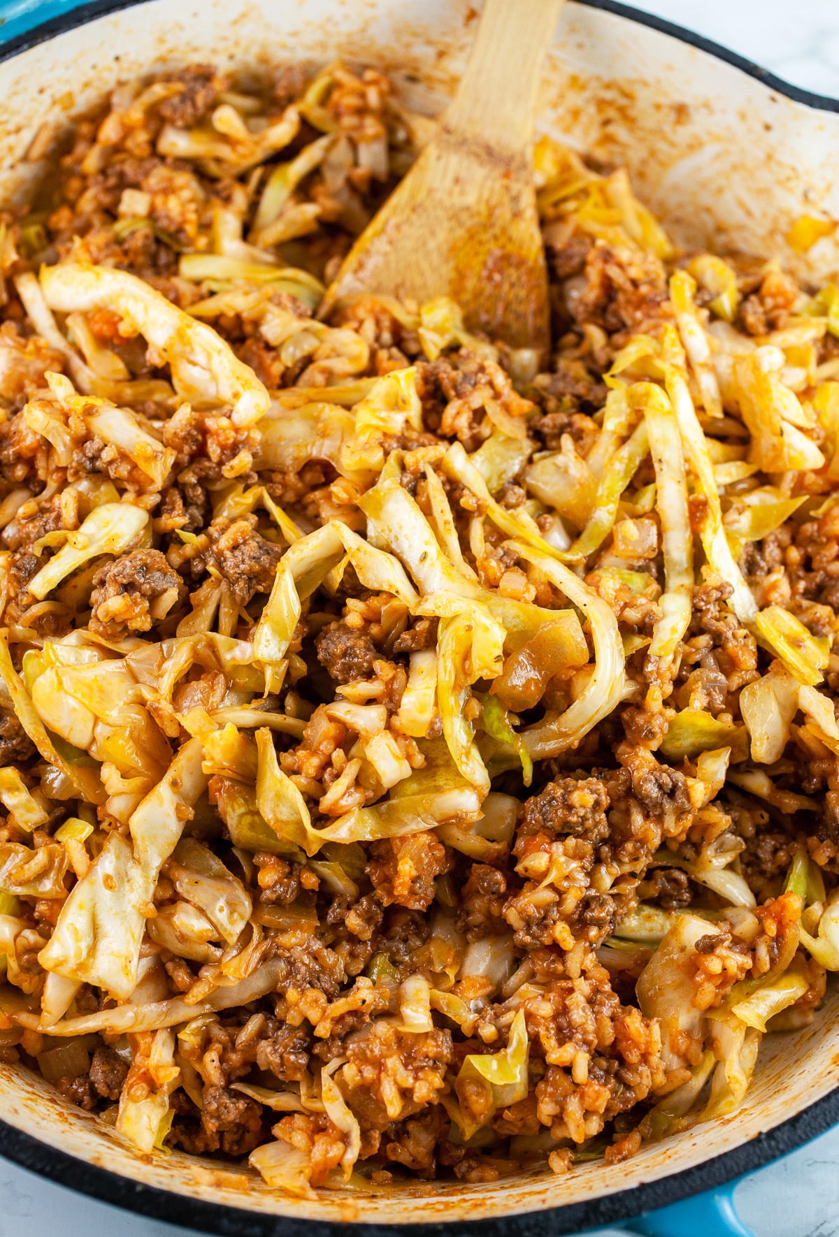 Cooked ground beef, cabbage, and rice mixture in skillet.