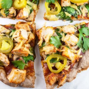 BBQ chicken pizza cut into slices.