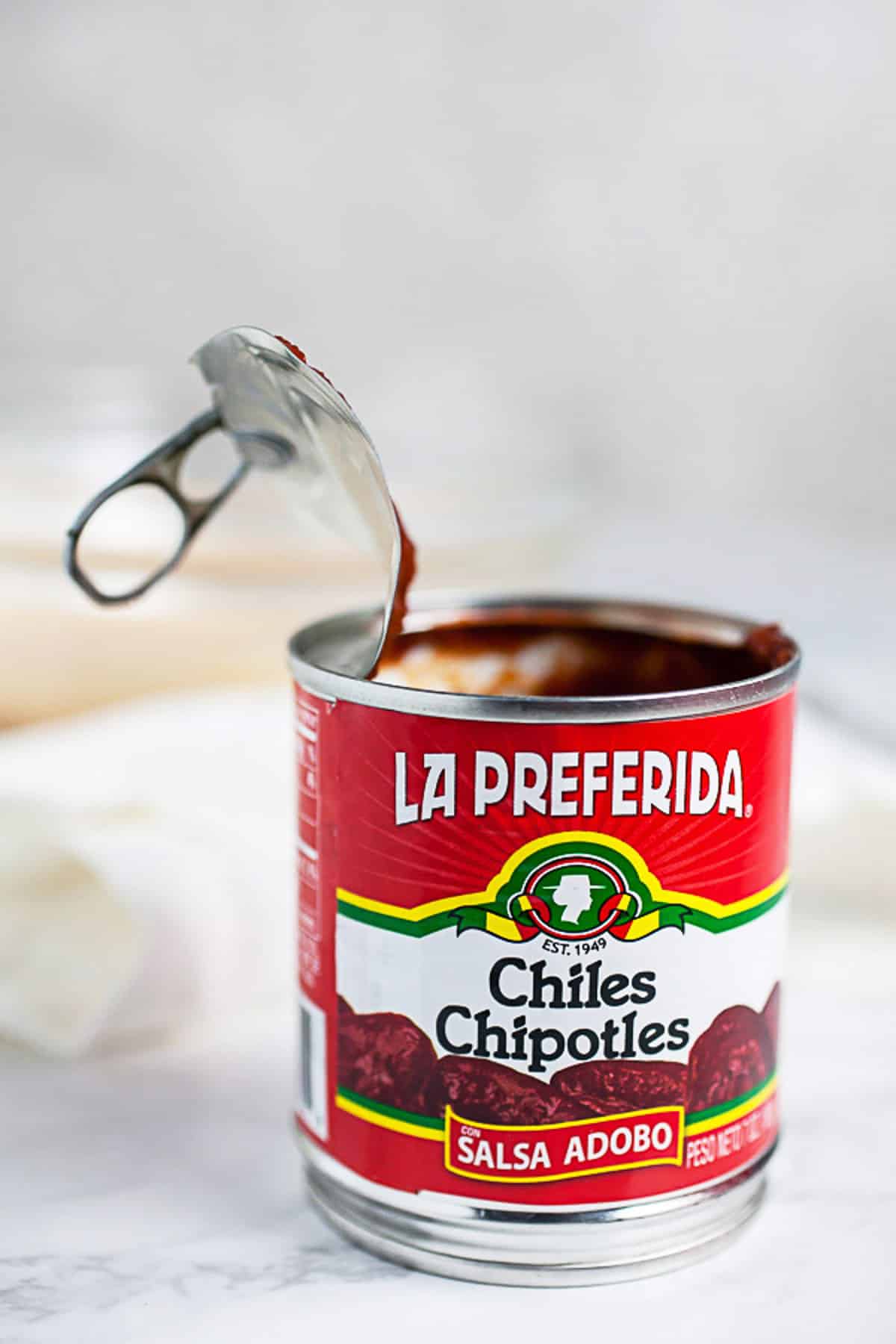 Opened can of chipotle peppers in adobo sauce.