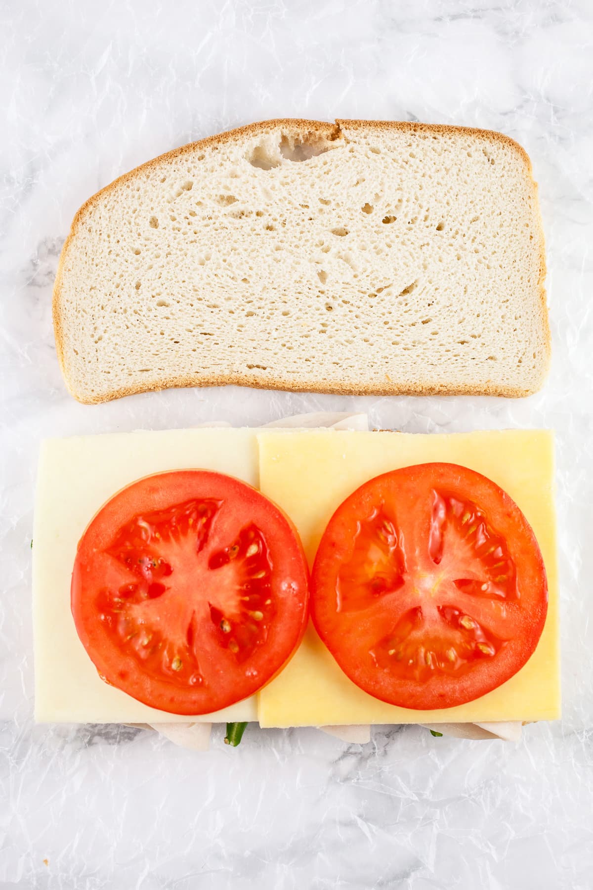 Sliced bread with cheese and tomatoes.