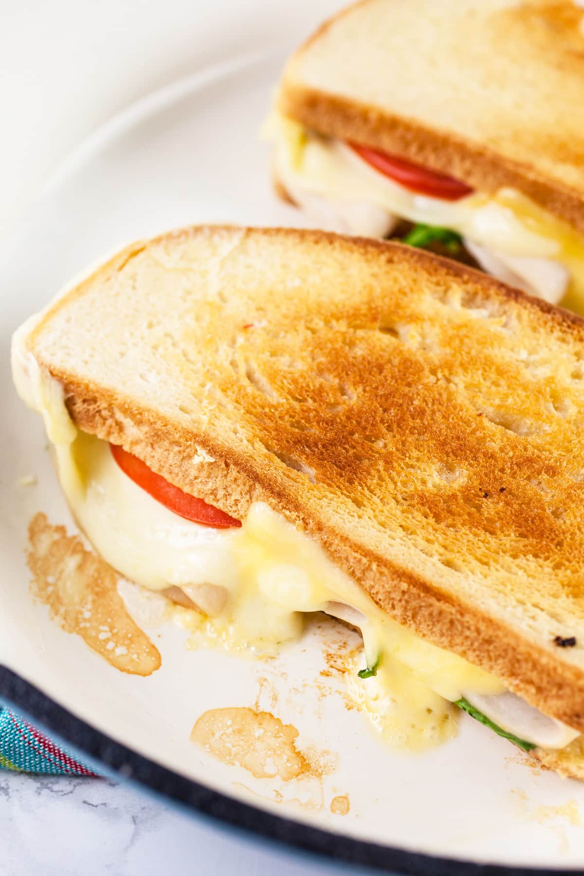 Toasted grilled cheese sandwiches in skillet.