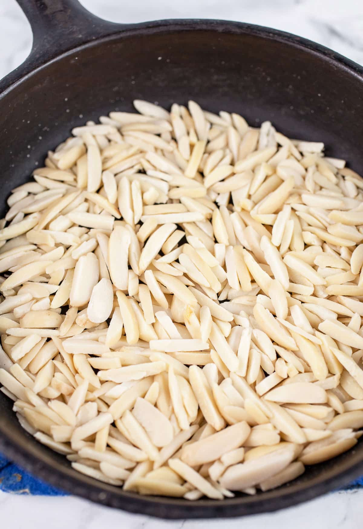 Toasted slivered almonds in small cast iron skillet.