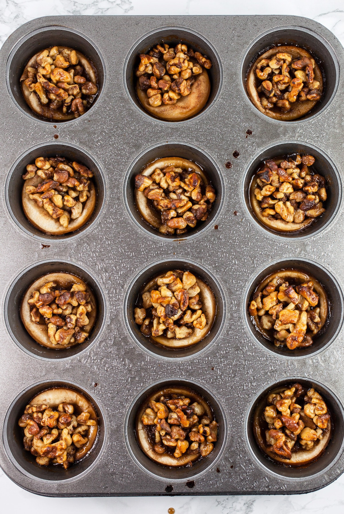 Baked baklava tartlets in muffin tin.