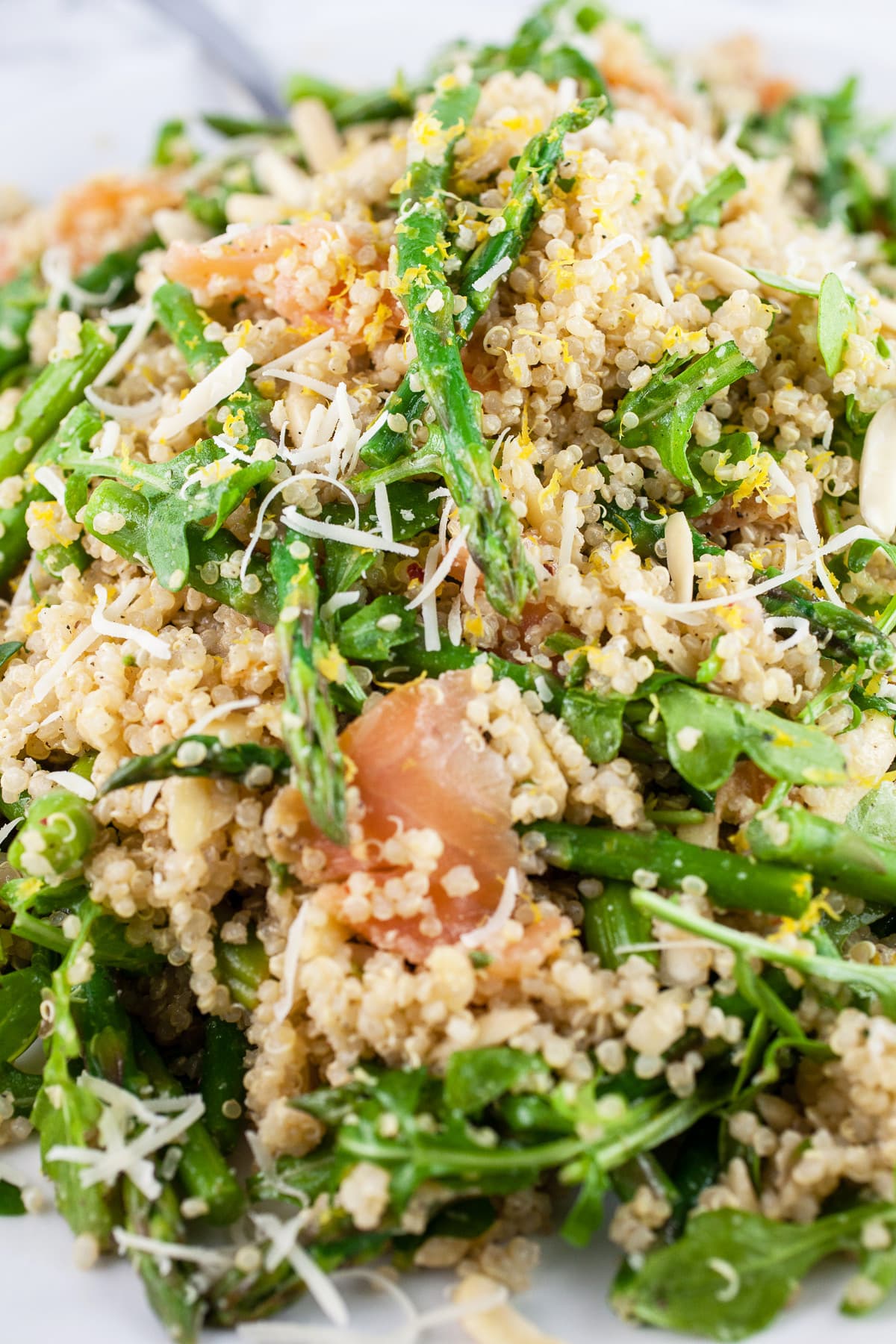 Smoked salmon arugula salad with asparagus on white platter.