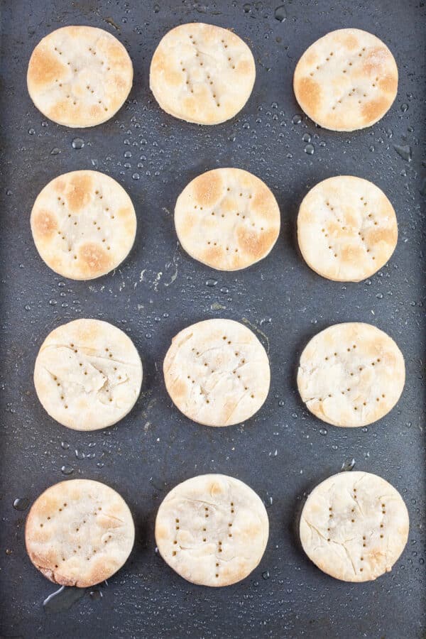 Baked puff pastry rounds on baking sheet.