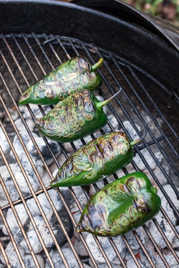 Roasted poblano peppers on charcoal grill.