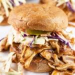 Shredded BBQ chicken sandwiches with coleslaw on toasted buns.