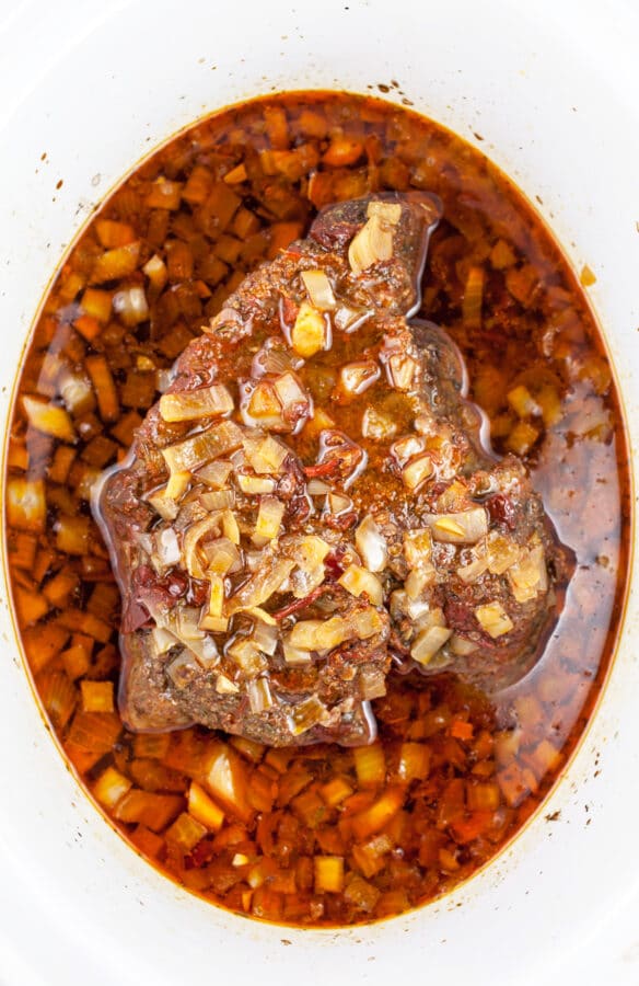 Cooked beef chuck roast in slow cooker.