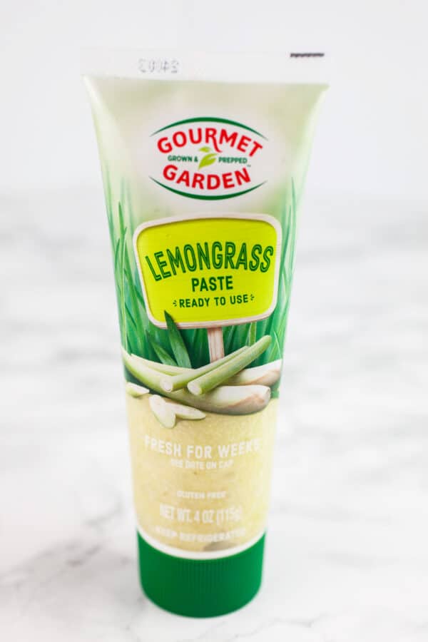 Tube of lemongrass paste on white surface.