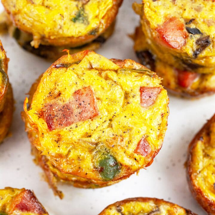 Denver omelette egg muffins stacked on white surface.