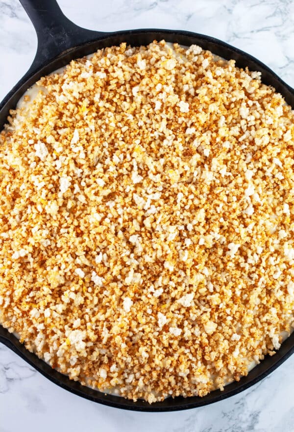 Gratin with breadcrumb topping in cast iron skillet.
