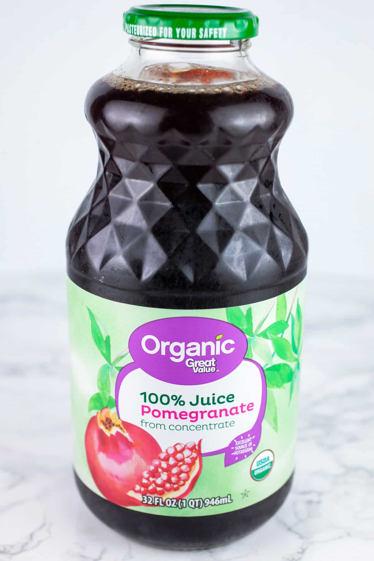 This Pomegranate Mojito Cocktail recipe is one of my favorite holiday cocktails! It's perfect for Christmas and New Year's Eve parties. It's made with rum, lime, and fresh mint. This festive drink is easy to prepare. Leave out the rum for a great mocktail version! #pomegranate #mojito #holidays #christmas Unopened glass jar of pomegranate juice.