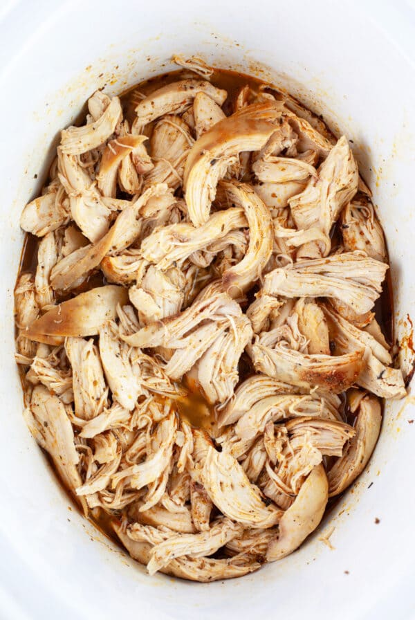 Cooked, shredded chicken breasts in slow cooker.