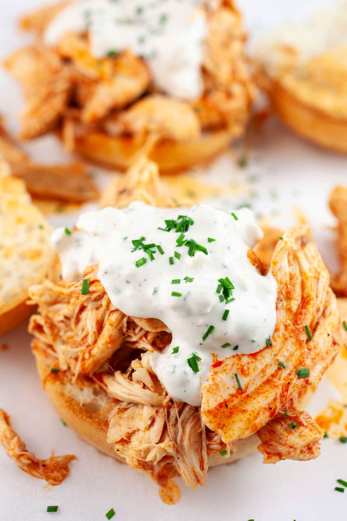 Open faced buffalo chicken sandwiches with blue cheese sauce.