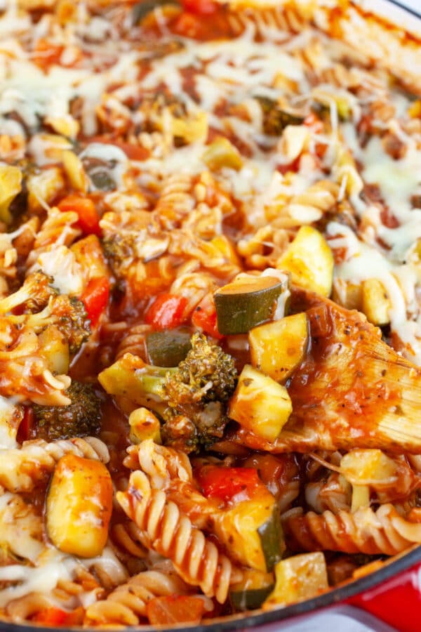 Cooked vegetable pasta in skillet with mozzarella cheese.