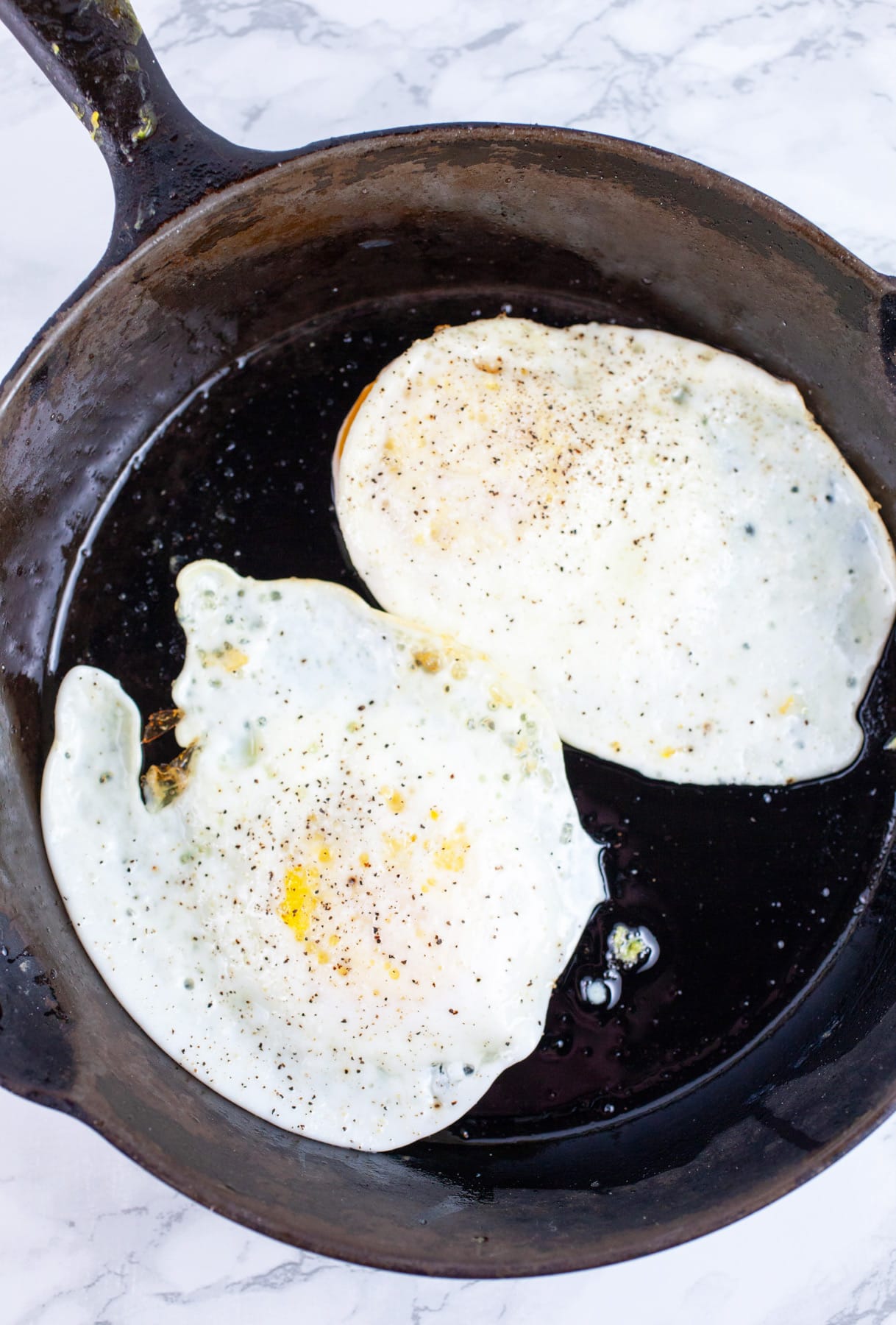 Over easy eggs cooked in small cast iron skillet.