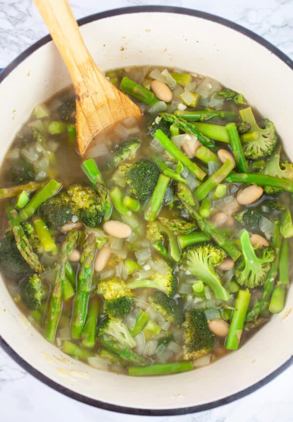 Cooked asparagus and broccoli soup in cast iron Dutch oven.