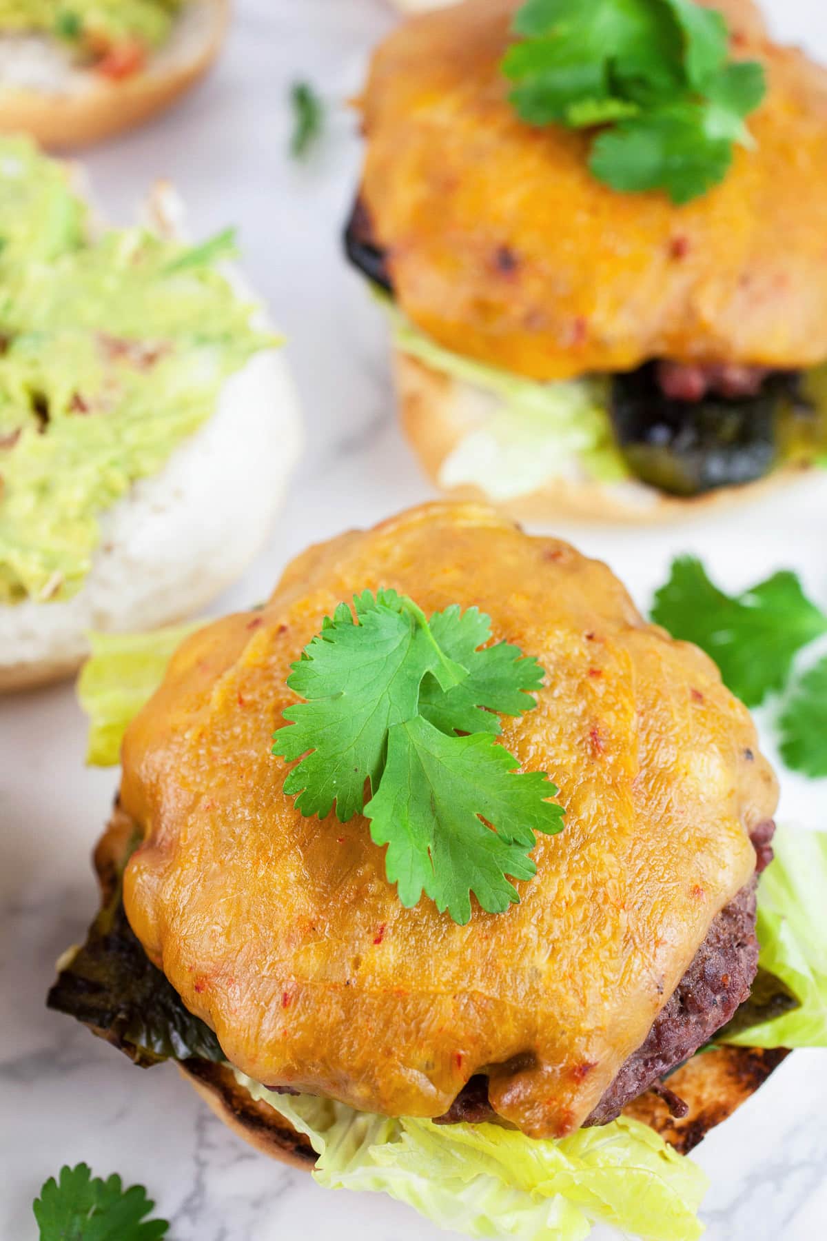 Southwest poblano burgers with melted cheese and cilantro.