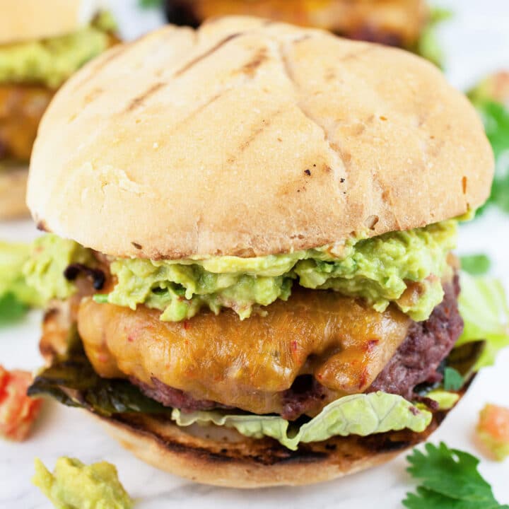 Grilled Southwest poblano burgers with avocado guacamole and cilantro.