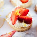Strawberry mascarpone tartlets with honey and lemon zest.