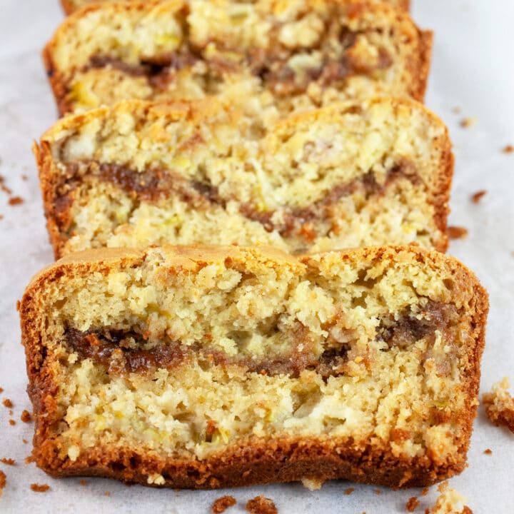 Slices of gluten free rhubarb bread on parchment paper.