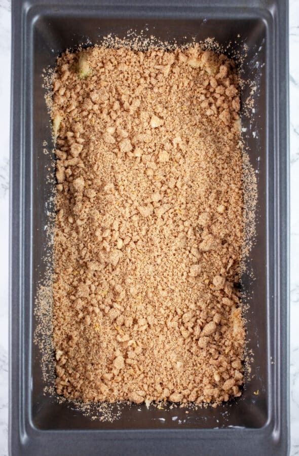 Layer of streusel added to metal bread pan.
