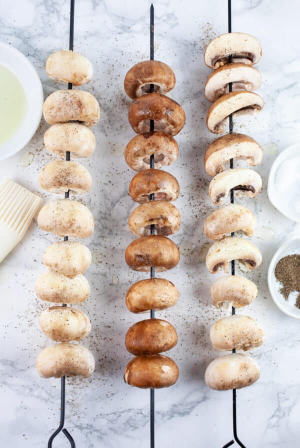 Mushrooms on skewers with olive oil, salt and pepper.