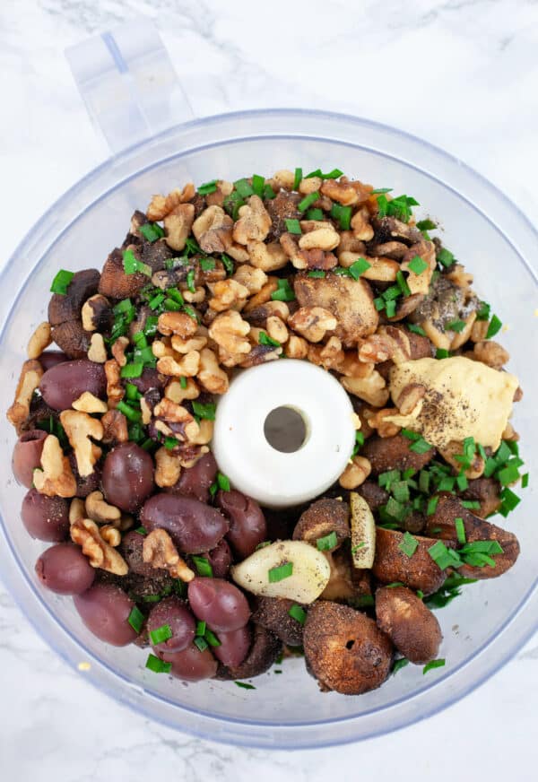 Grilled mushrooms, Kalamata olives, garlic, walnuts, Dijon mustard, and minced chives in food processor.